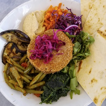 Bowl of veggies, a veggie burger, and Maltese bread at Soul Food, one of the best Valletta restaurants