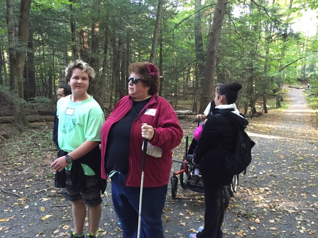 Accessible outdoor activities: a woman guiding another woman on a hike