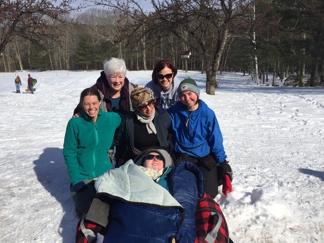 People participating in accessible outdoor activities in the snow