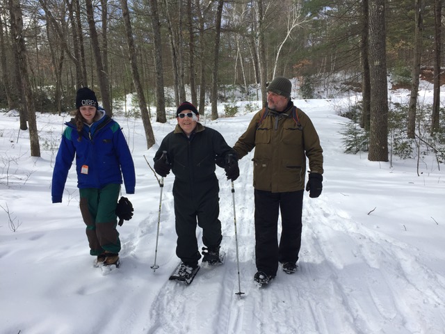 Three people walking in the snow