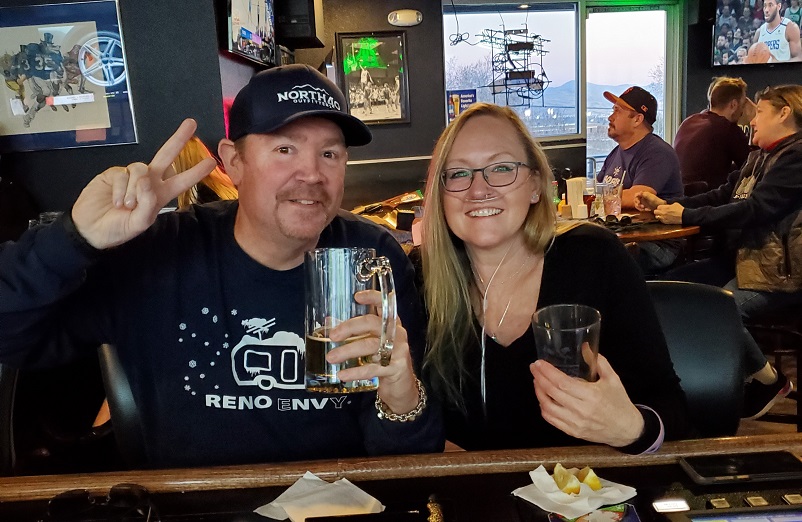 Dina sitting with her husband at a bar