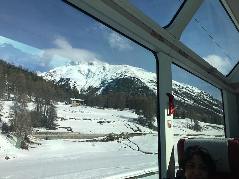 A snowy mountain seen as seen out the windows of the Glacier Express, one of the most scenic train rides in Europe