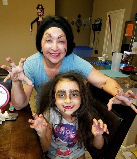 Maria and her granddaughter wearing make-up making memories