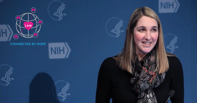 Steph, a woman, standing in front of a blue background with NIH logos; WWLAM 2020 logo in upper left corner