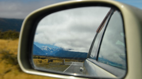 Rearview mirror showing mountain landscape