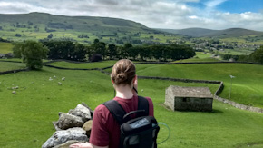 Back view of Sarah with her portable oxygen concentrator taking a photo in the Yorkshire Dales