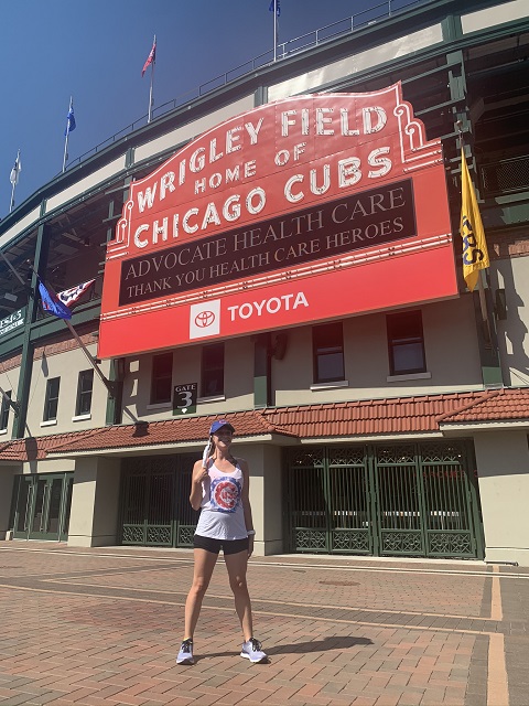 Alex (a woman with LAM) standing in front of Wrigley Field in Chicago