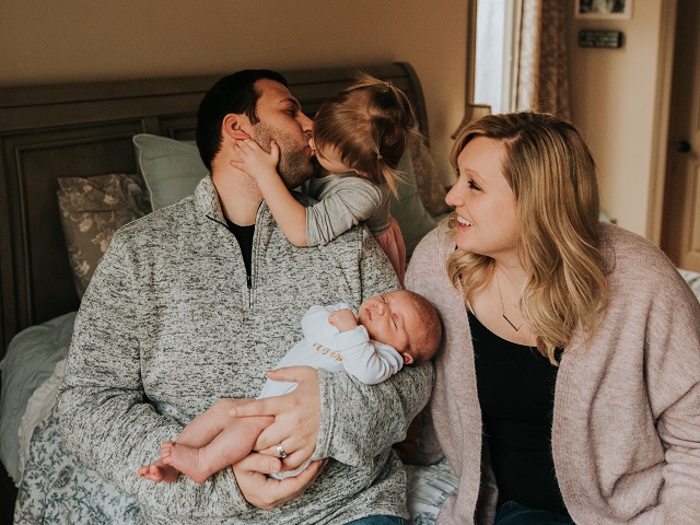 Meagan - a woman with LAM - with her husband and two daughters