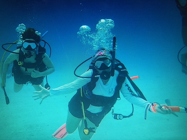 Sarah SCUBA diving with her daughter